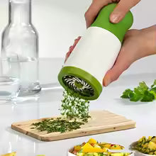 Manual herb grinder minces parsley, chili, cilantro, spices, vegetables efficiently.